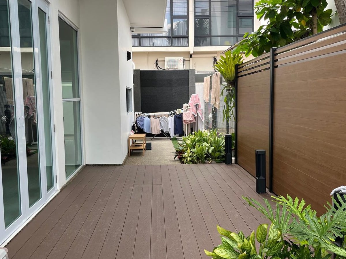 Aluminium decking along a residential corridor with planting