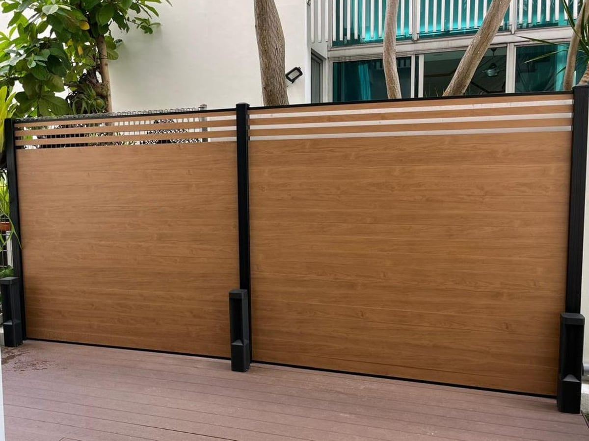 Aluminium fencing panels with timber look finish enclosing a Singapore property
