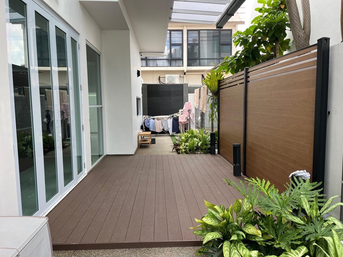 Aluminium decking along a residential corridor with planting